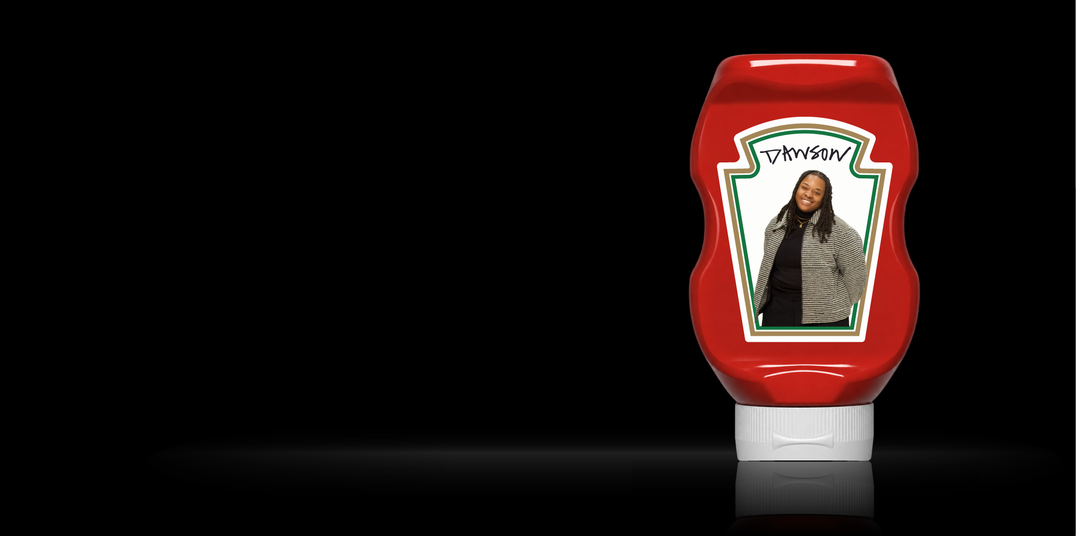Ketchup bottle with a Dawson label featuring Jerrayah Dawson's portrait, reflected on a black surface