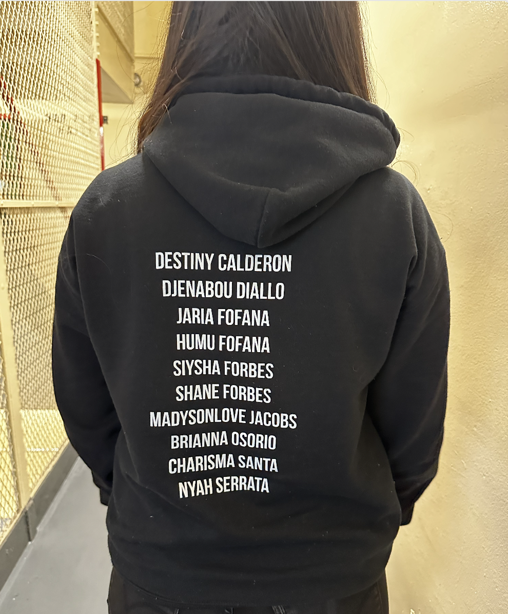 Back of a black hoodie printed with a list of team member names