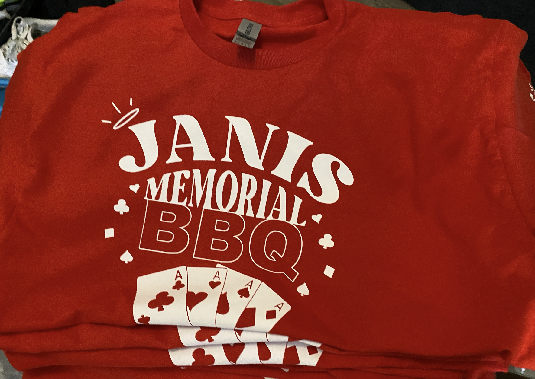 Red "Janis Memorial BBQ" tee with playing card graphics