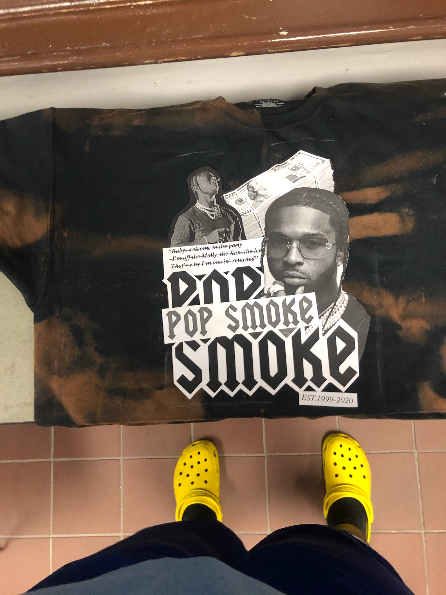 Pop Smoke graphic sweatshirt laid flat on a tiled floor