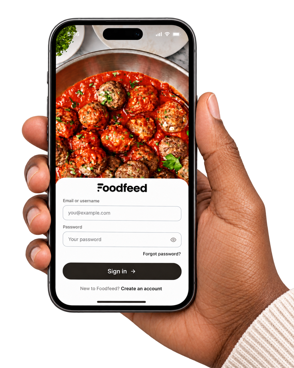 Hand holding an iPhone showing the Foodfeed sign-in screen