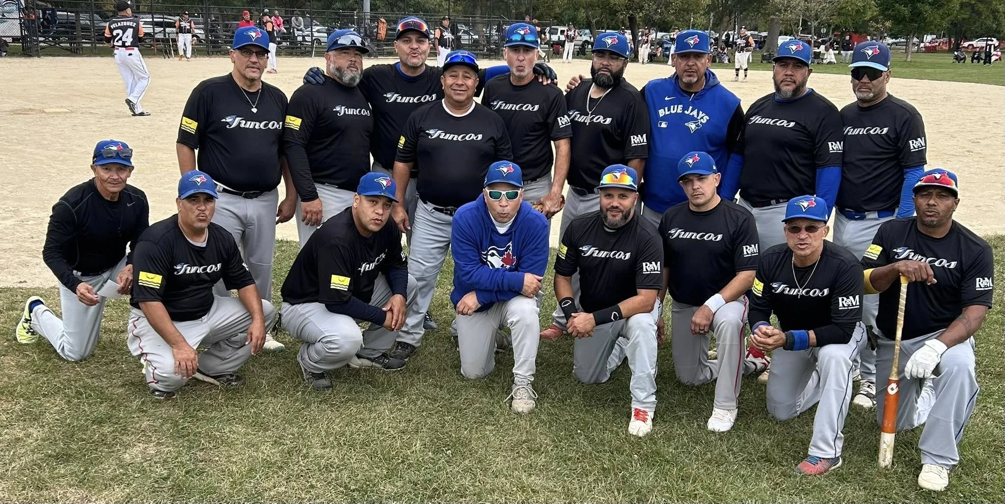 Men's softball team posing in custom navy jerseys