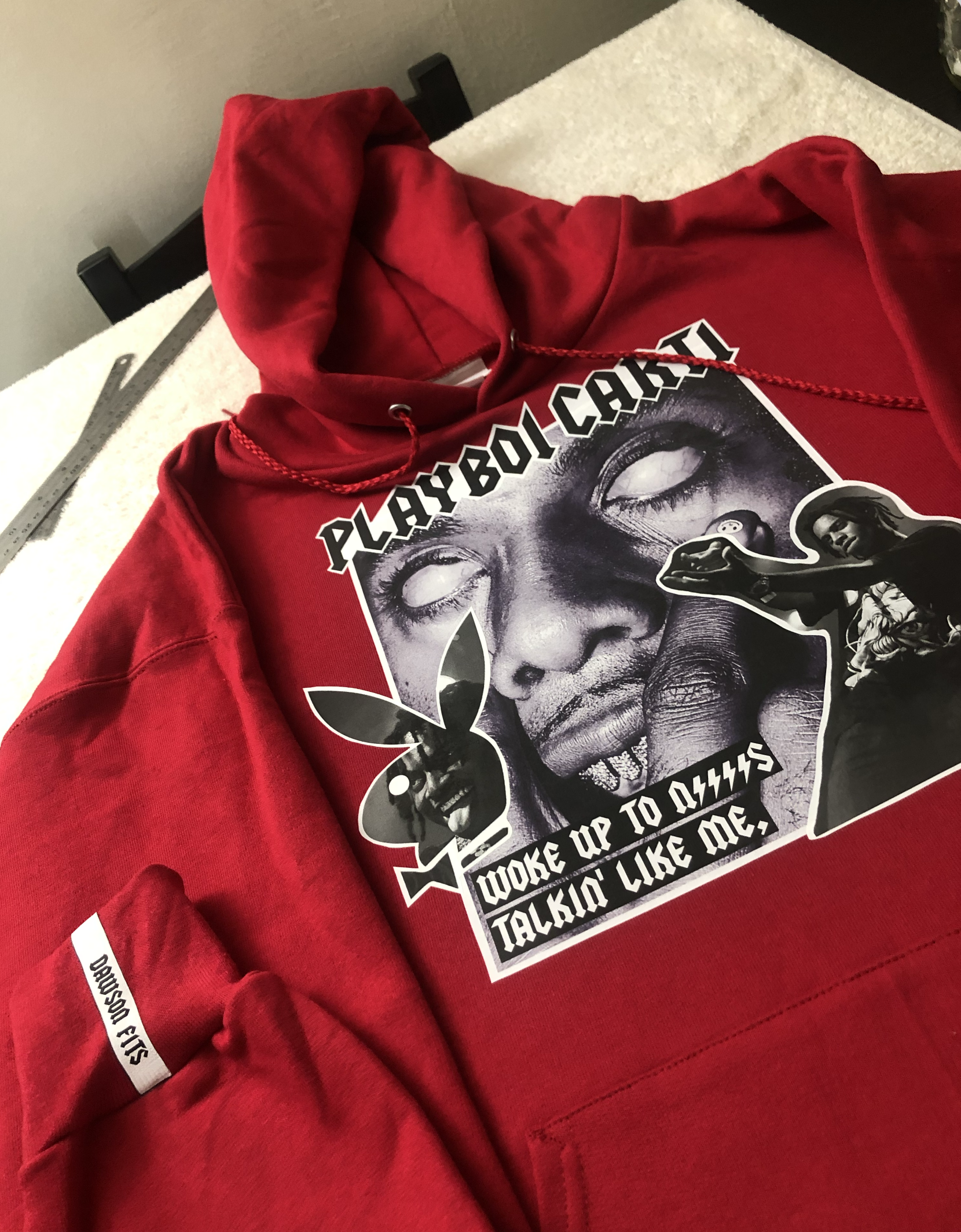 Red hoodie with a Playboi Carti graphic print