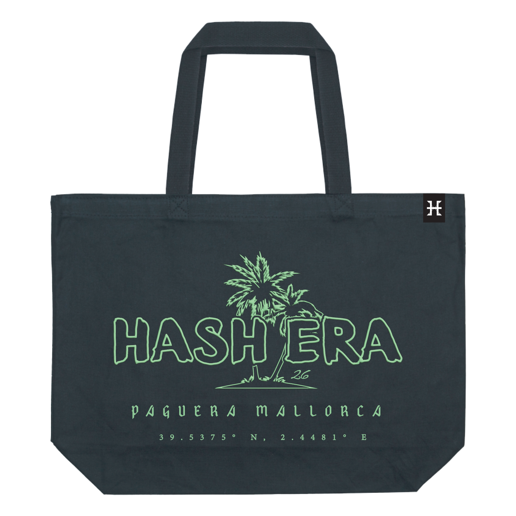 Close-up of a black tote bag with green outline text and a palm tree graphic on the front, featuring the words "Hashera" and "Paguera Mallorca" along with geographical coordinates.