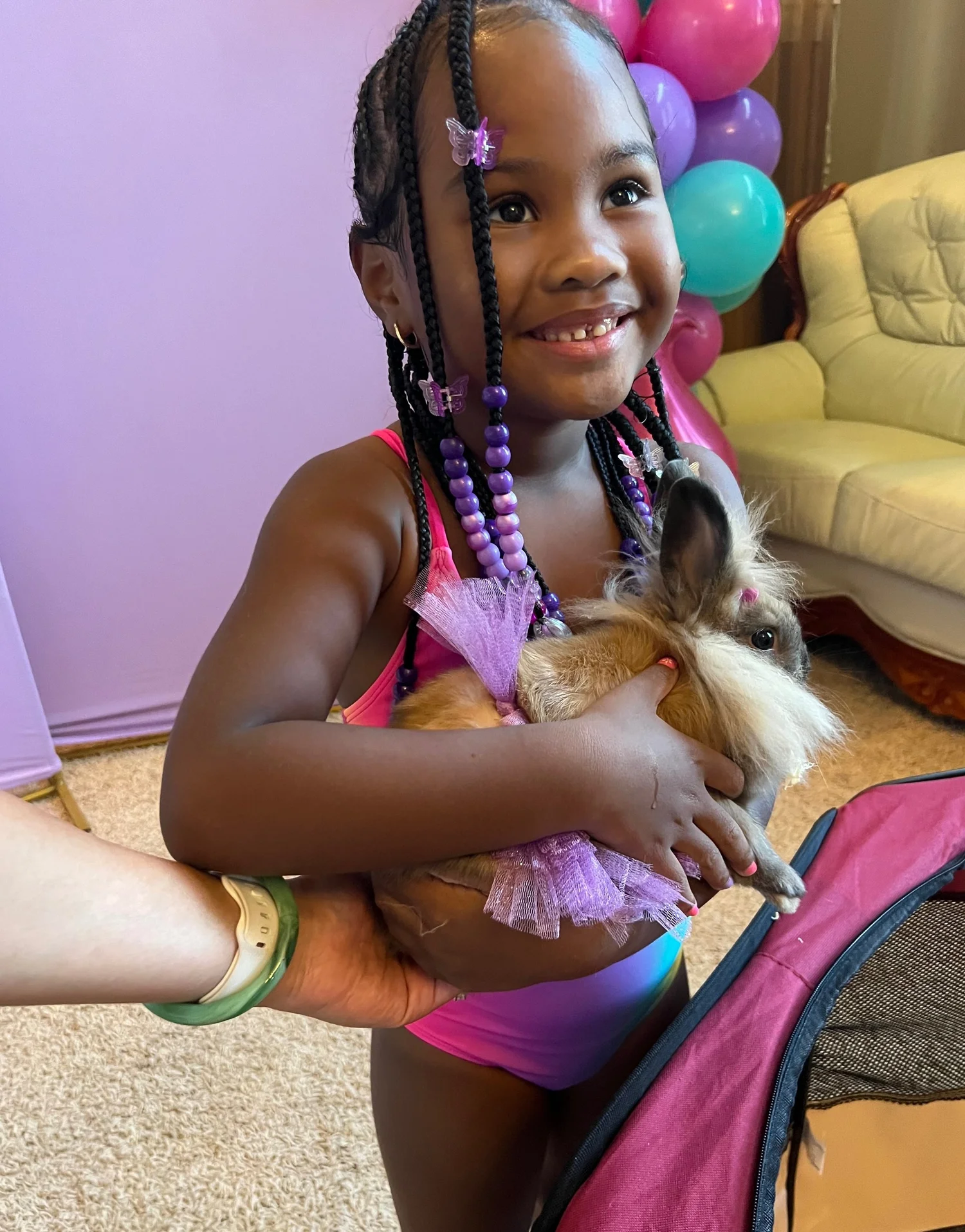A party guest holding a bunny