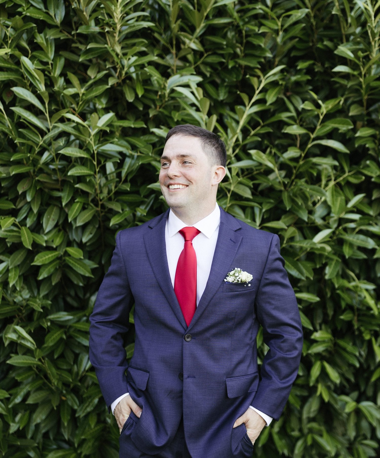 A smiling member of the Poff Farmily in a blue suit outdoors