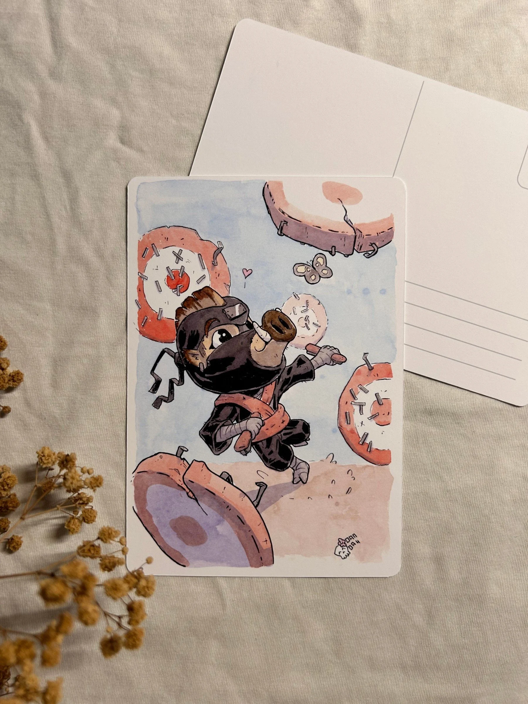 Wild boar ninja leaping between stapled practice targets on an A6 postcard, ink and watercolor illustration.