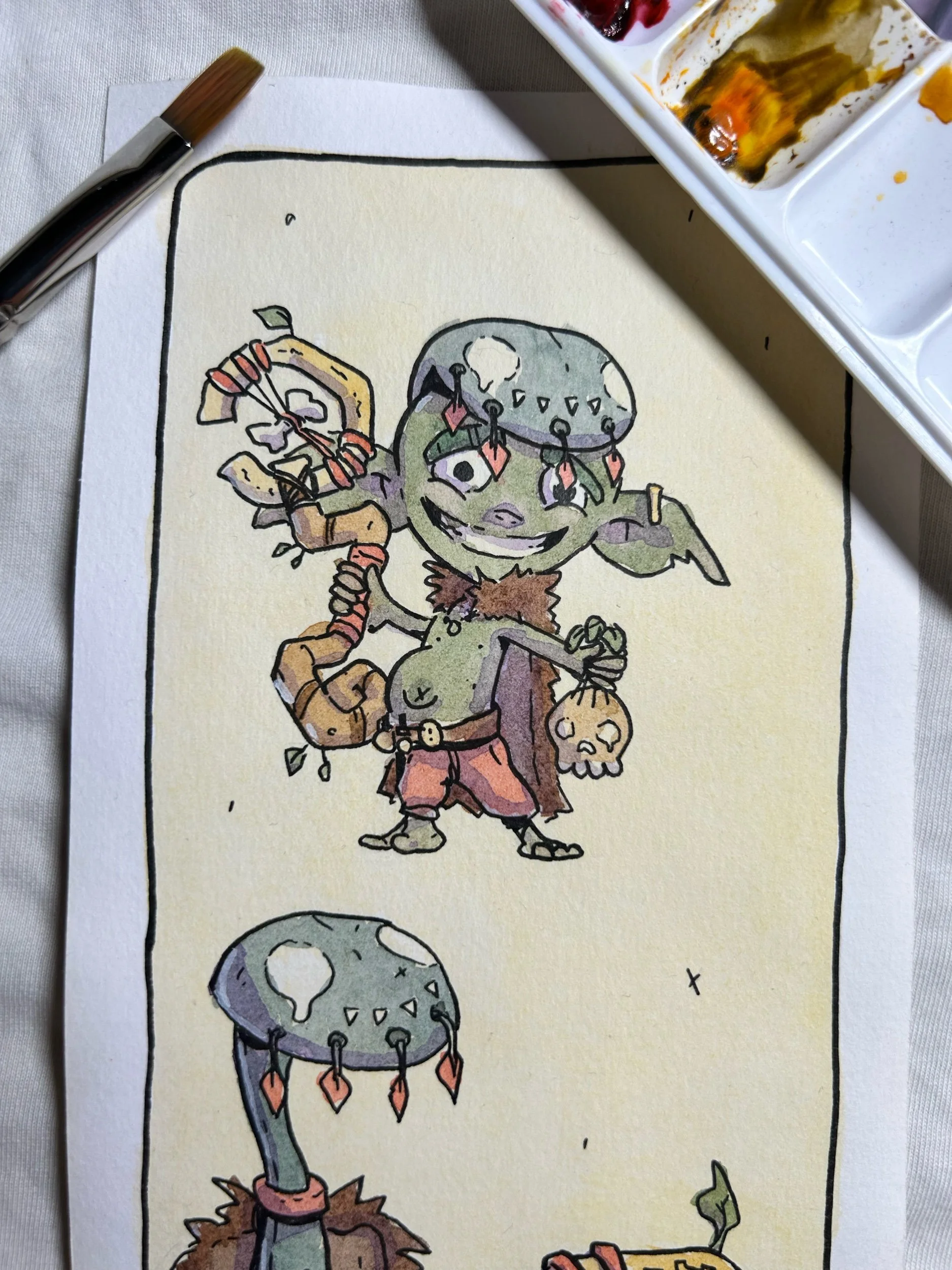 Close-up of a green goblin witchdoctor in a stone helmet, ink and watercolor illustration on cream paper.
