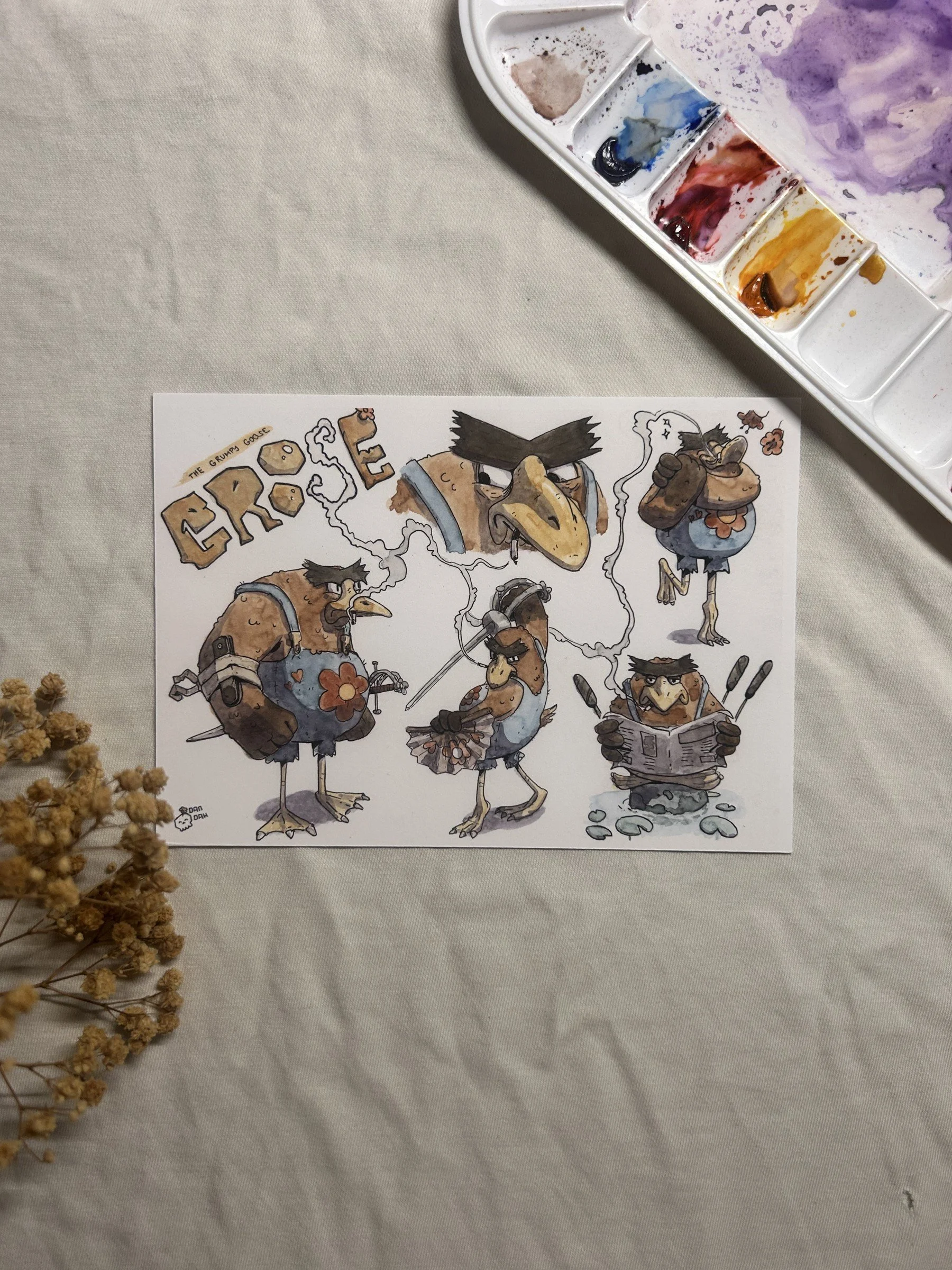 groose-postcard-1.jpgGroose the grumpy goose in five poses, ink and watercolor character sheet on a postcard beside a paint palette.