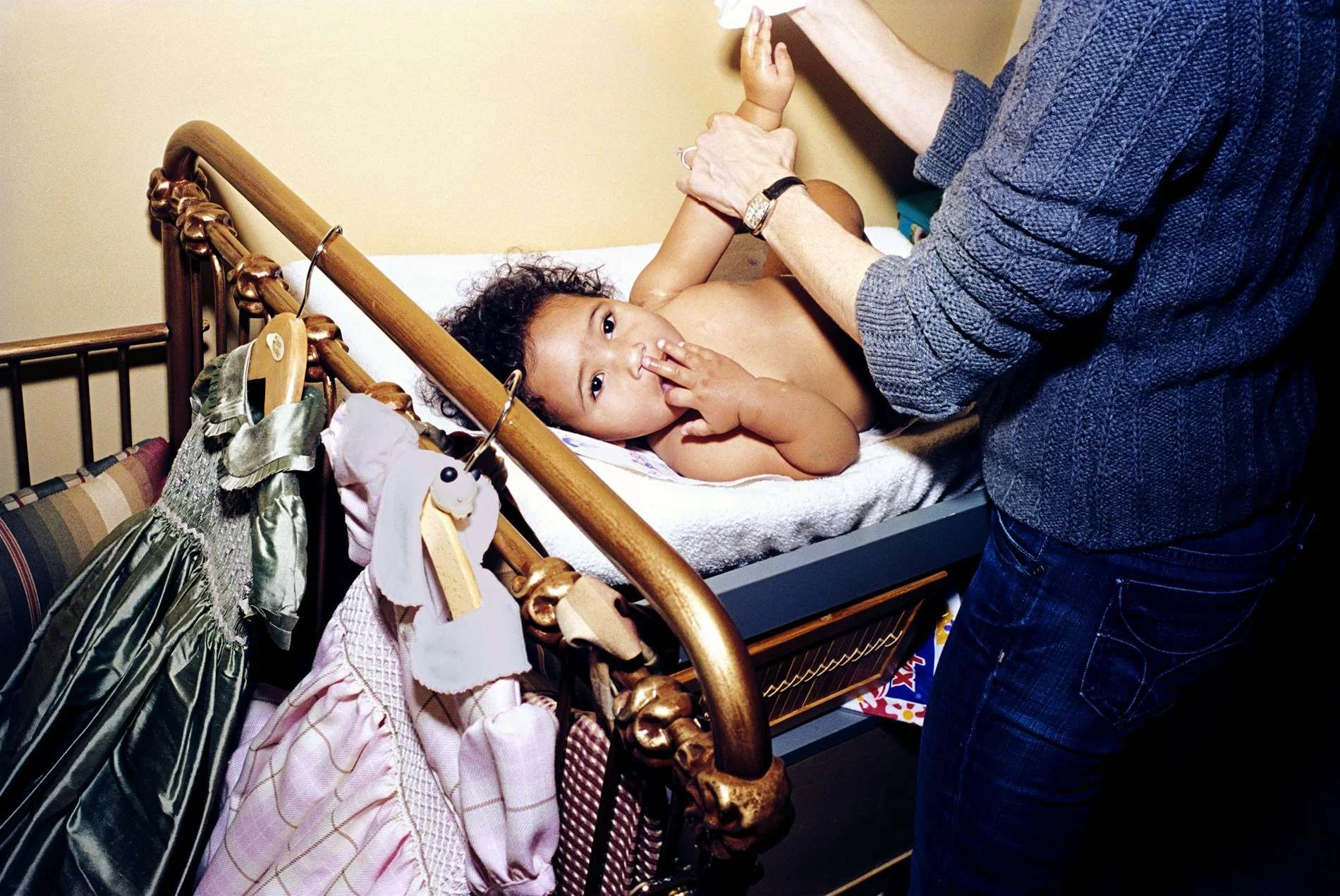 Mother changed her  baby daughter shot at home with real film by Angela Cappetta on location in NYC on Central Park West.  