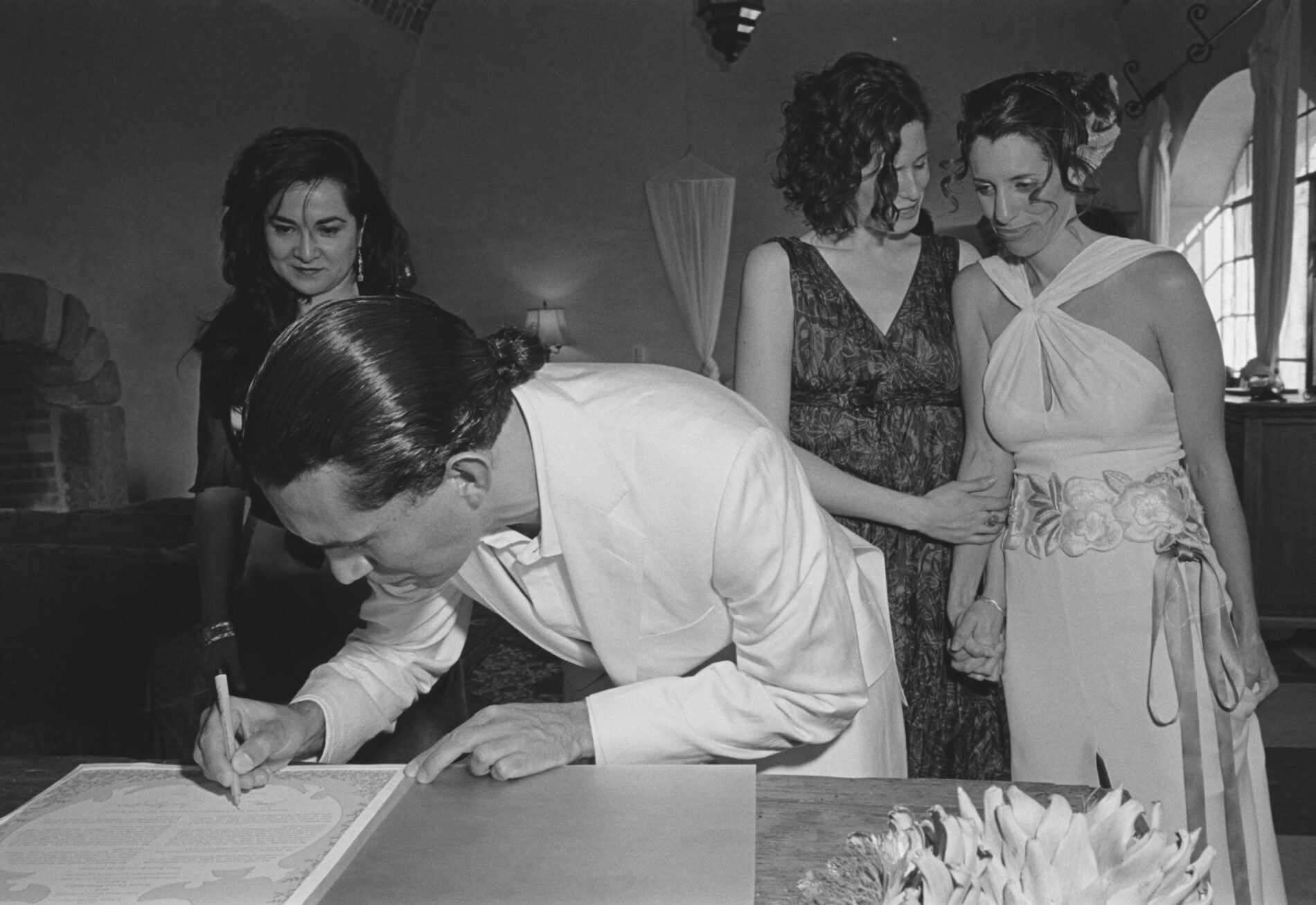 Jennie and Enrique sign their ketubah. Shot on location in Mexico.