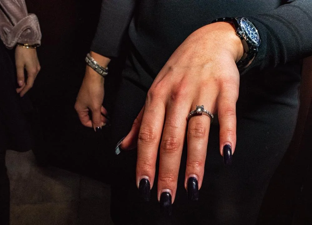 A newly engaged bride shows off her ring.