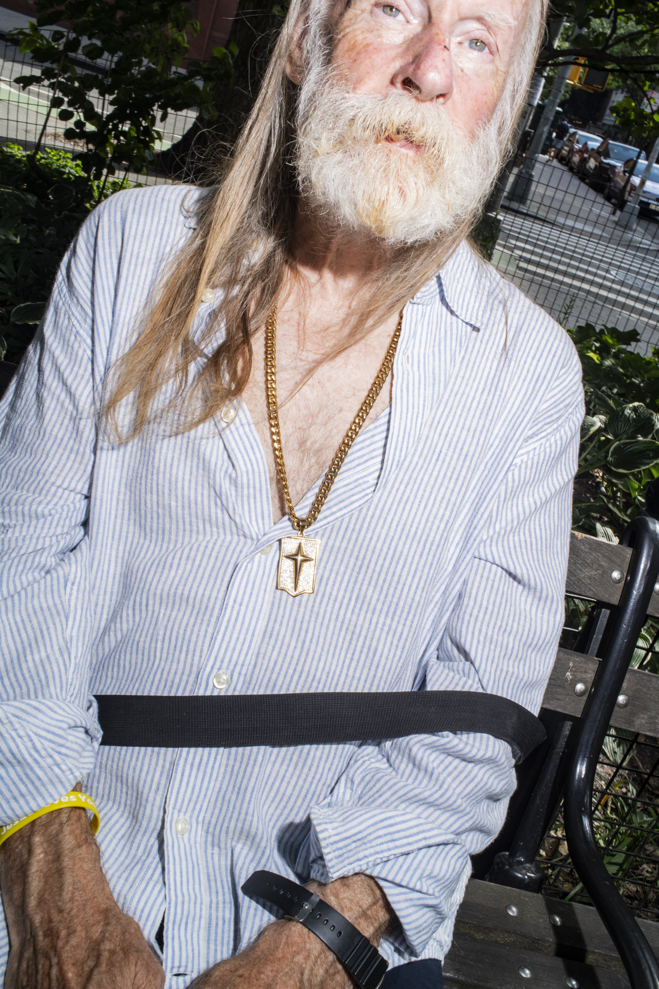 Man wearing a necklace with a large gold pendant in New York City
