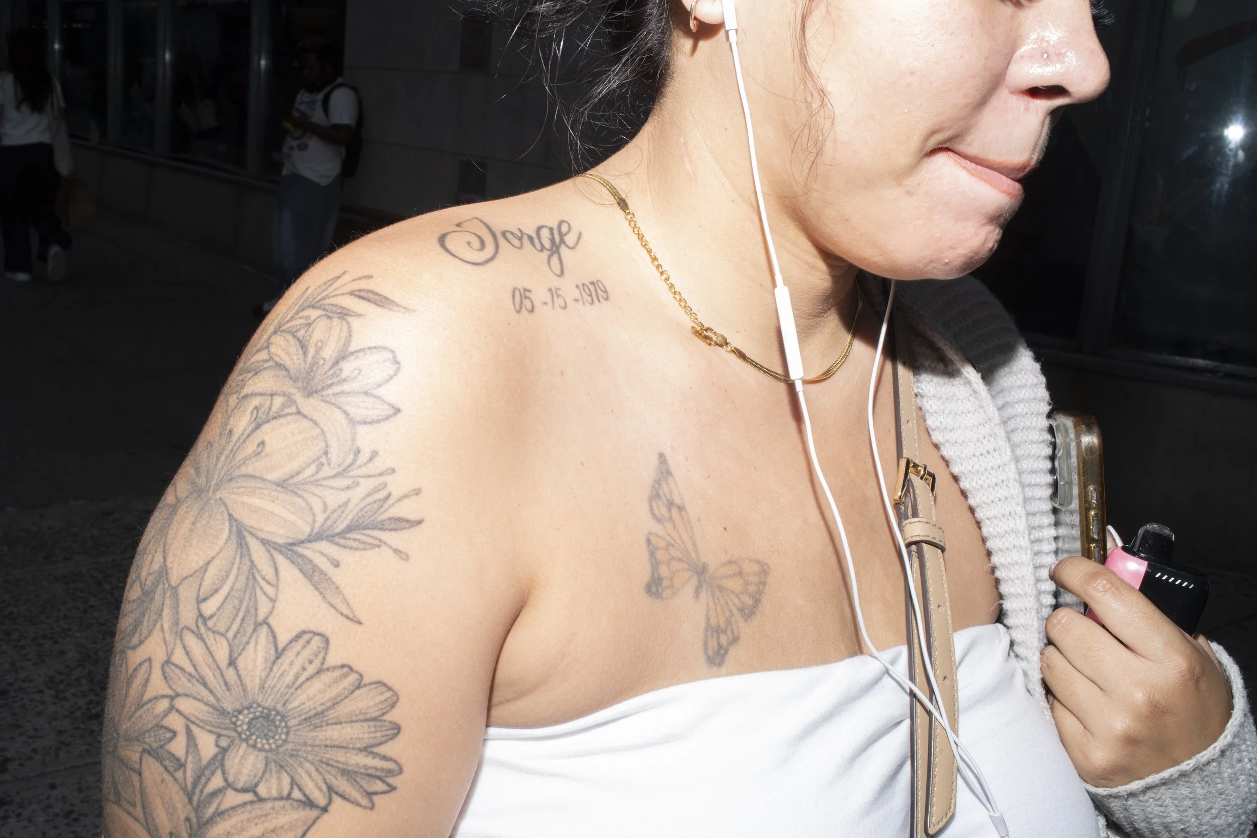 Portrait of a woman wearing a gold necklace and earbuds shot in Manhattan