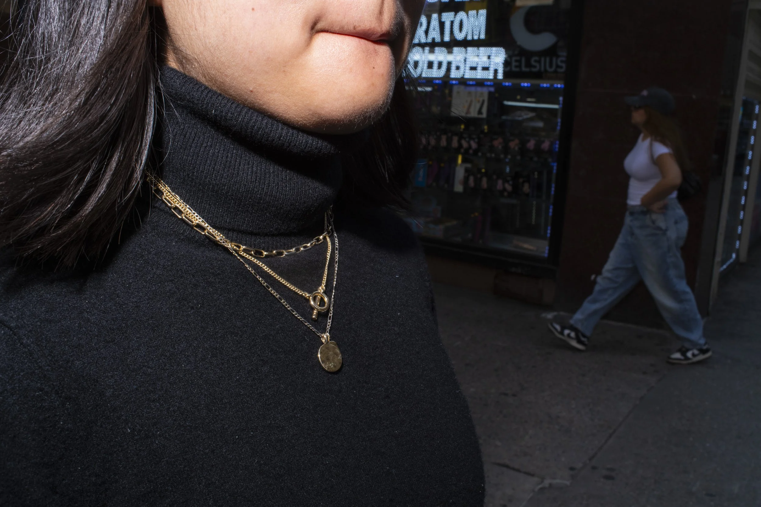 Portrait of a woman wearing a gold necklaces over a black sweater shot in Manhattan