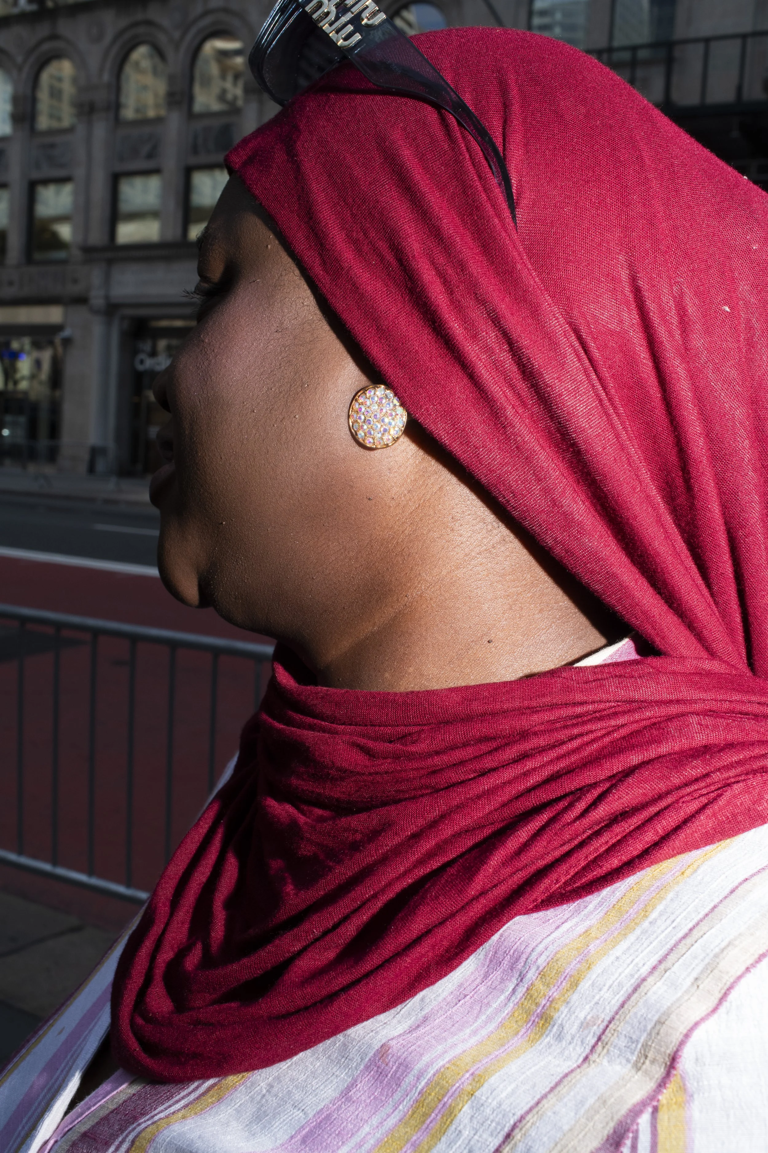Hijabi woman wearing gold earrings and jewelry photographed on a New York City street