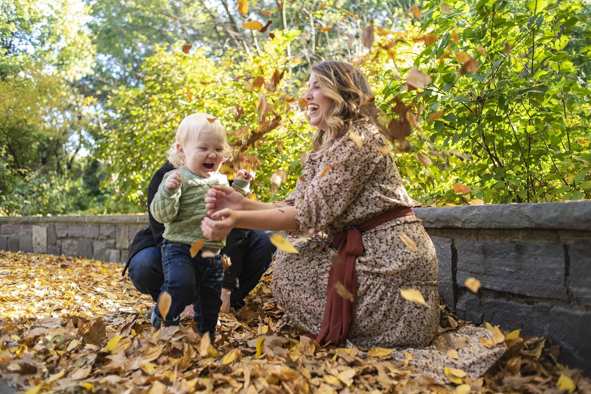 Family portraits of a baby playing in autumn leaves shot in Central Park by Angela Cappetta. 