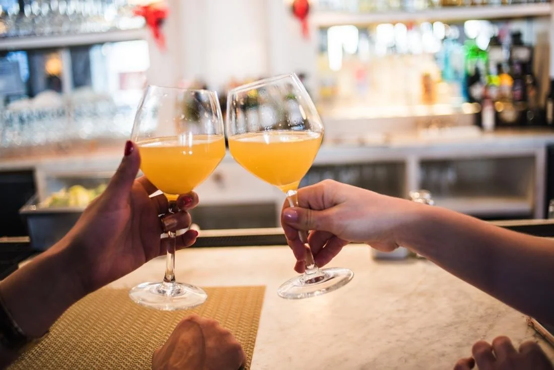 Morning brunch cocktails clink at a reception