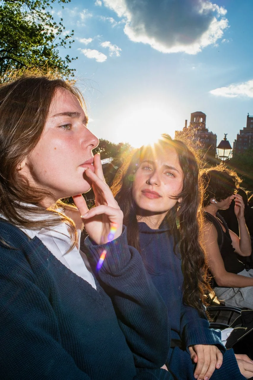 Street photo of women smoking on a park bench NYC