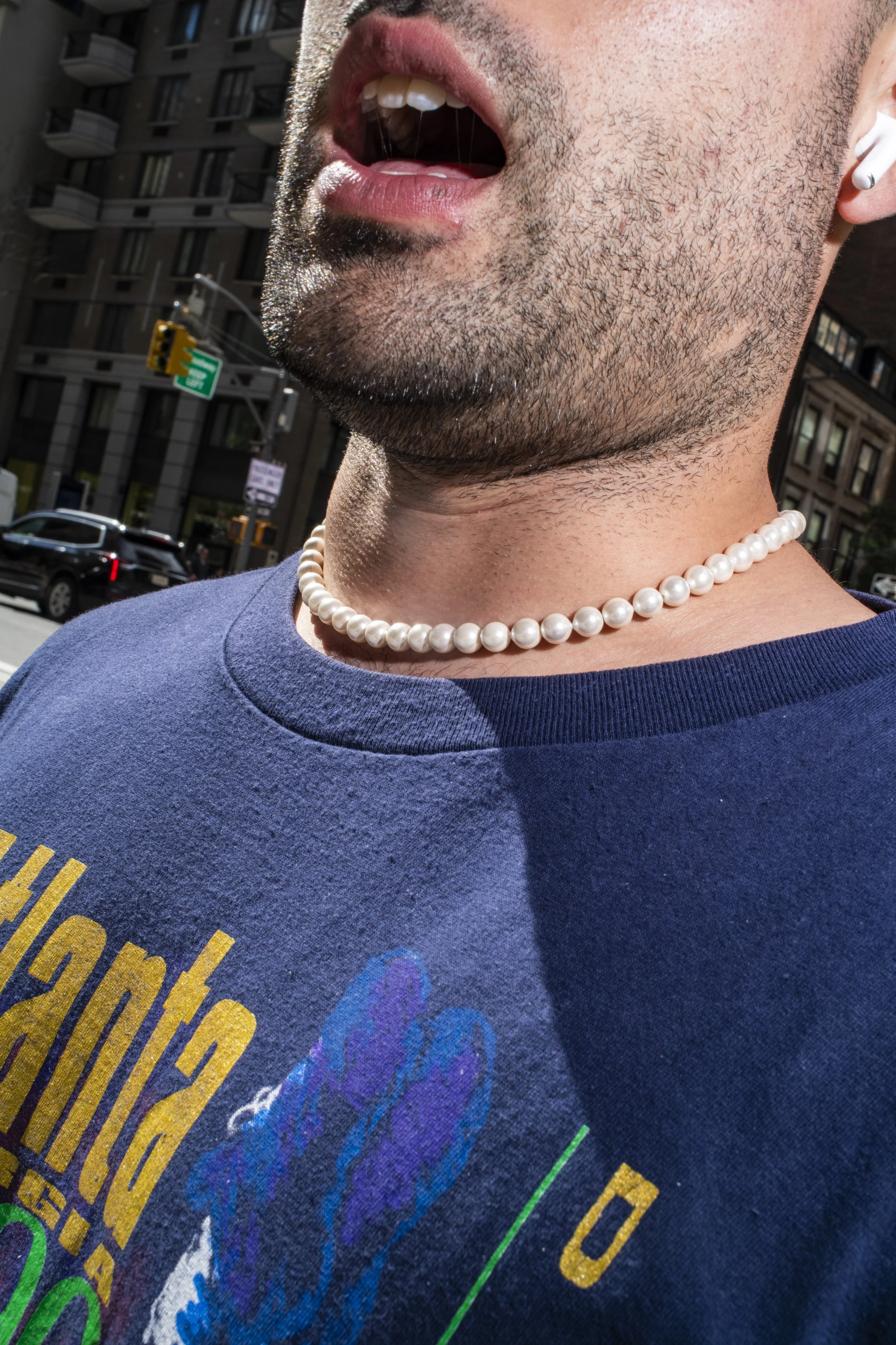 Young man wears his mom's pearl choker
