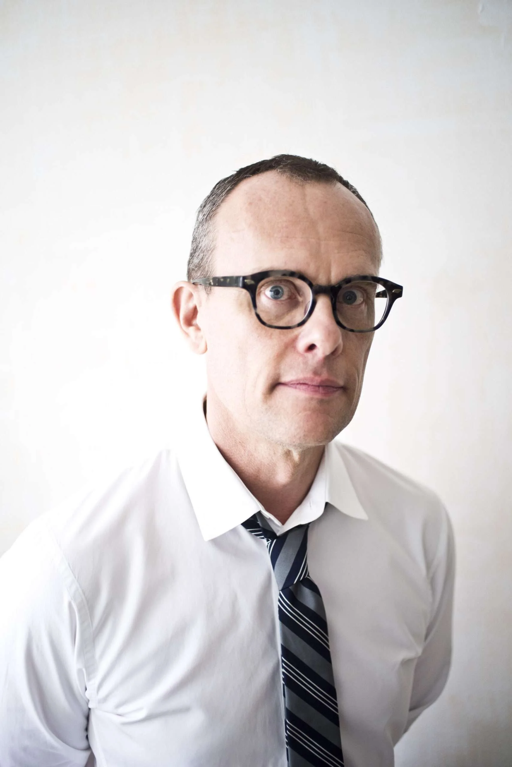 Executive headshot of a professional in a New York City studio using natural and studio lighting