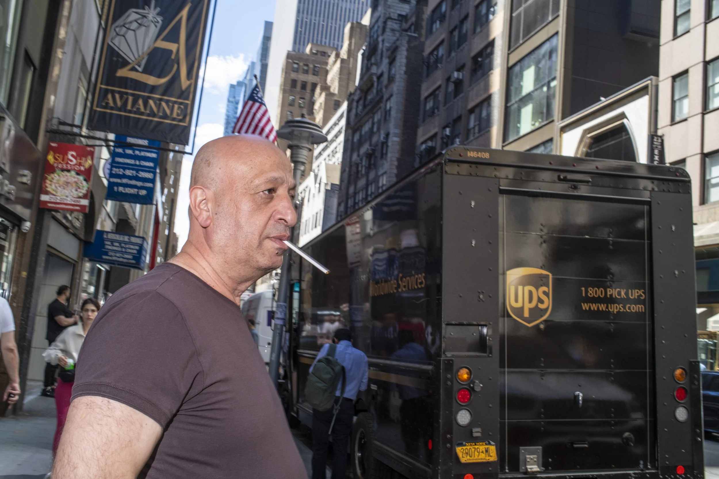 Man smokes outside on 47th Street