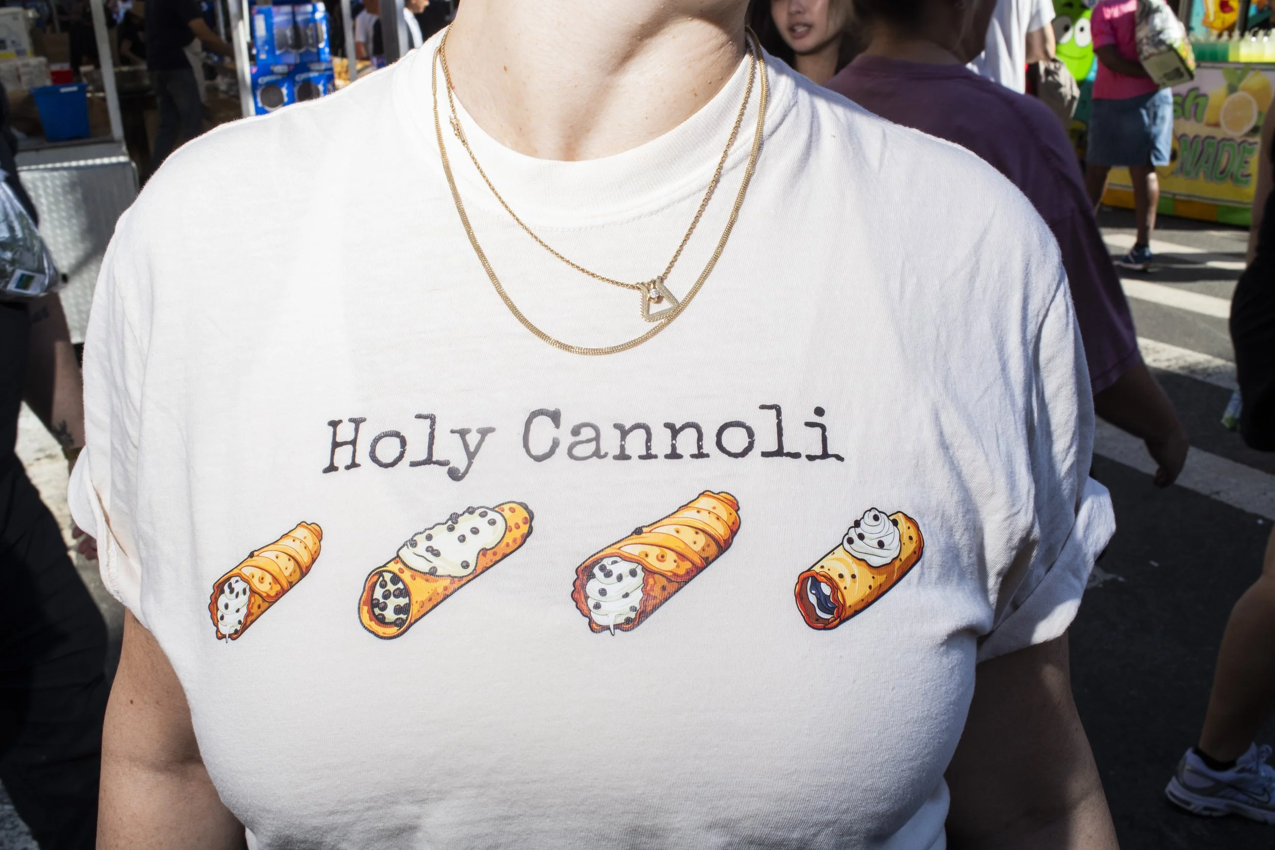 Woman wearing multiple tiny gold chains on a New York City street