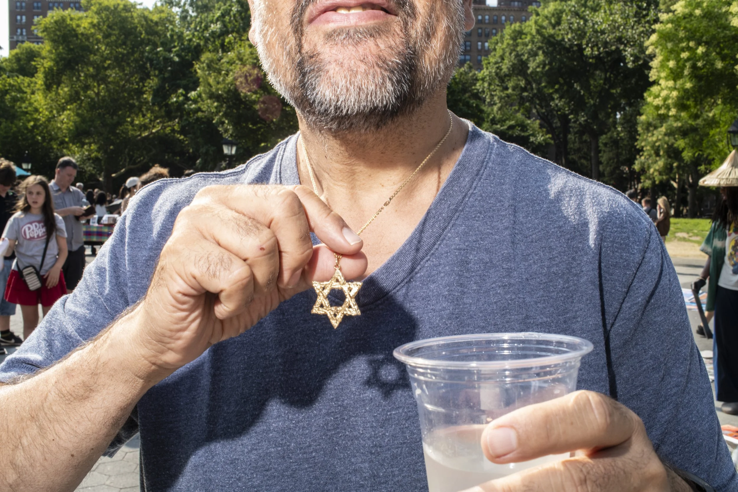 Man wearing a necklace with a religious pendant in New York City