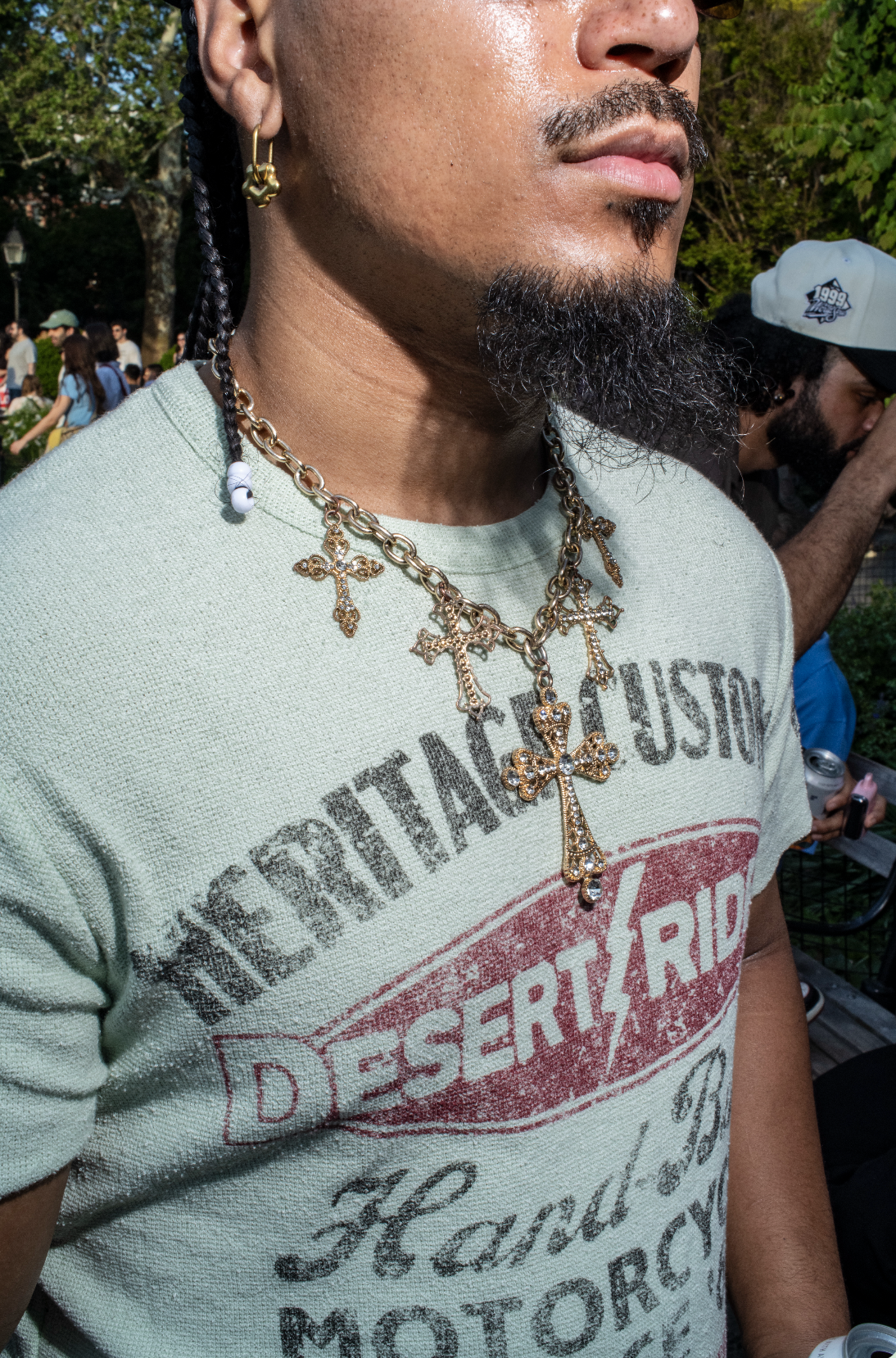 Man wearing a necklace with a multiple charms in New York City