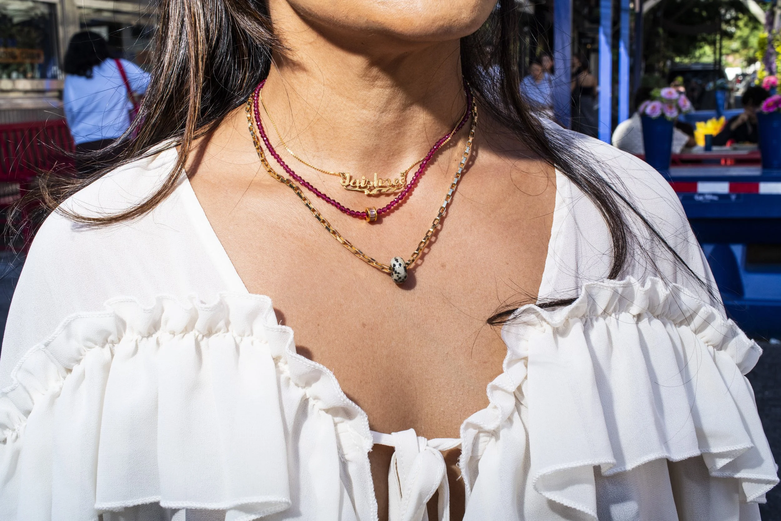 Portrait of a woman wearing a gold necklace and beads in Manhattan