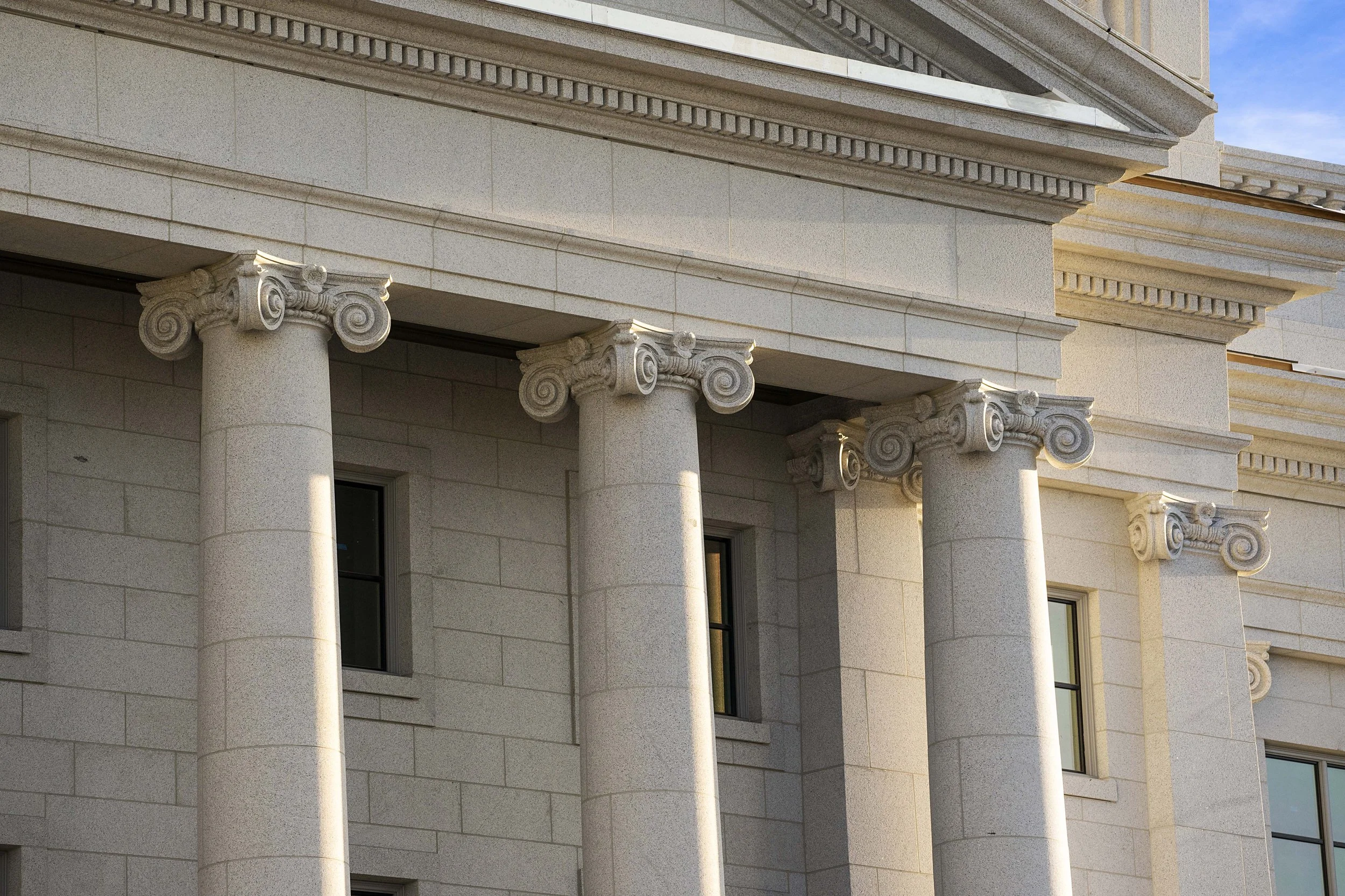 Close-up of a government or institutional building with stone pillars and classical architectural details.