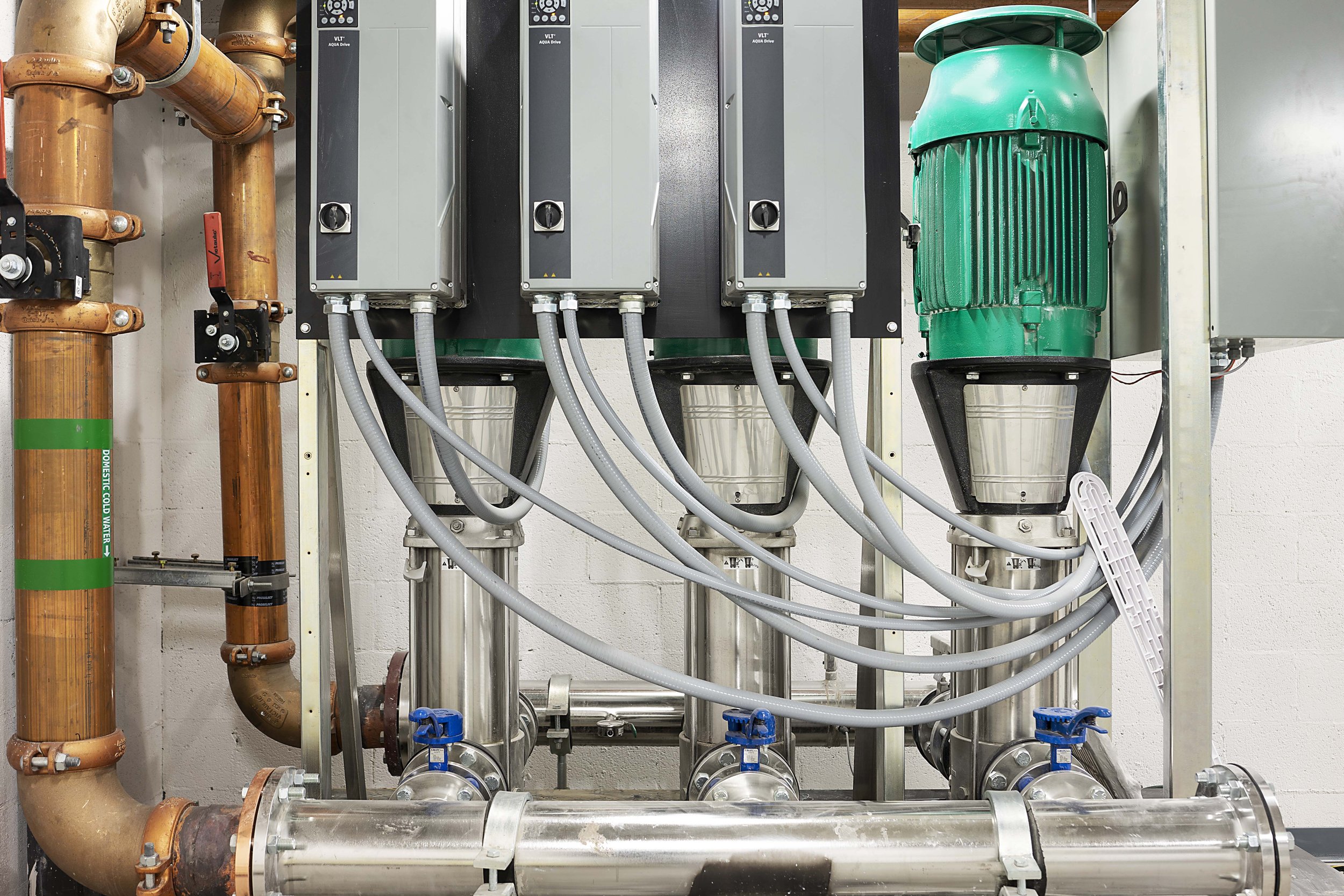 Industrial machinery with pipes, metal tanks, and electrical components.