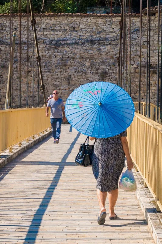 Woman with parasol on Berat footbridge