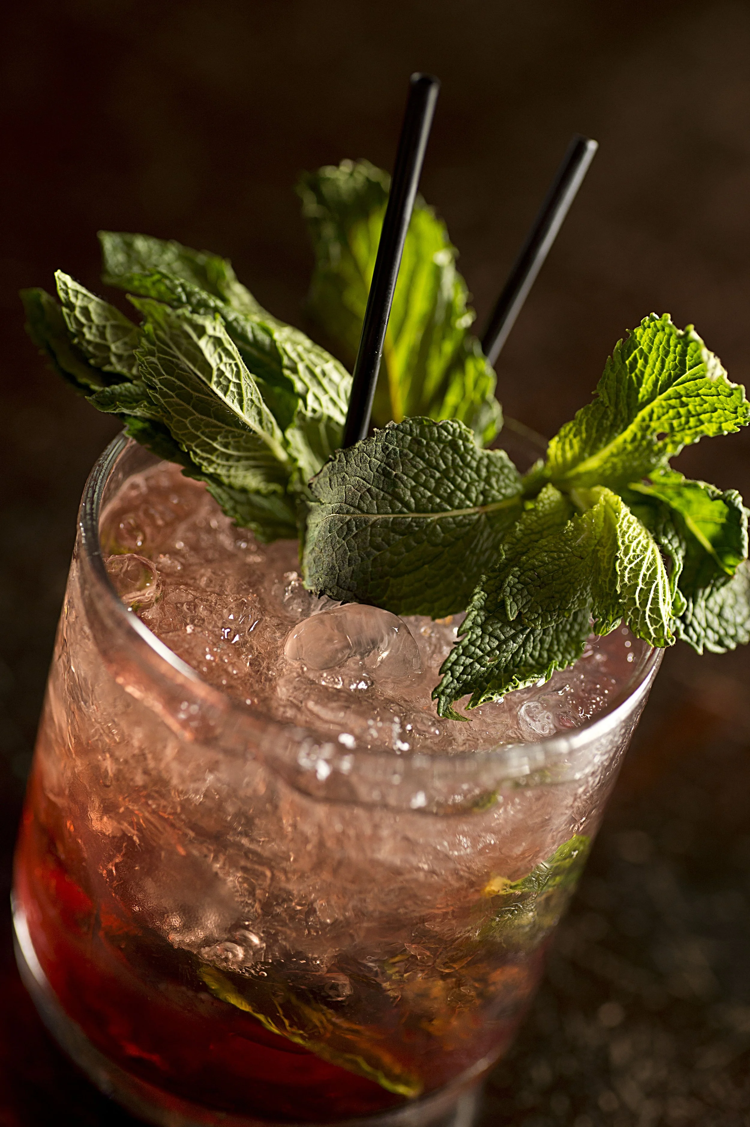 Close-up of a cocktail garnished with fresh mint leaves and ice