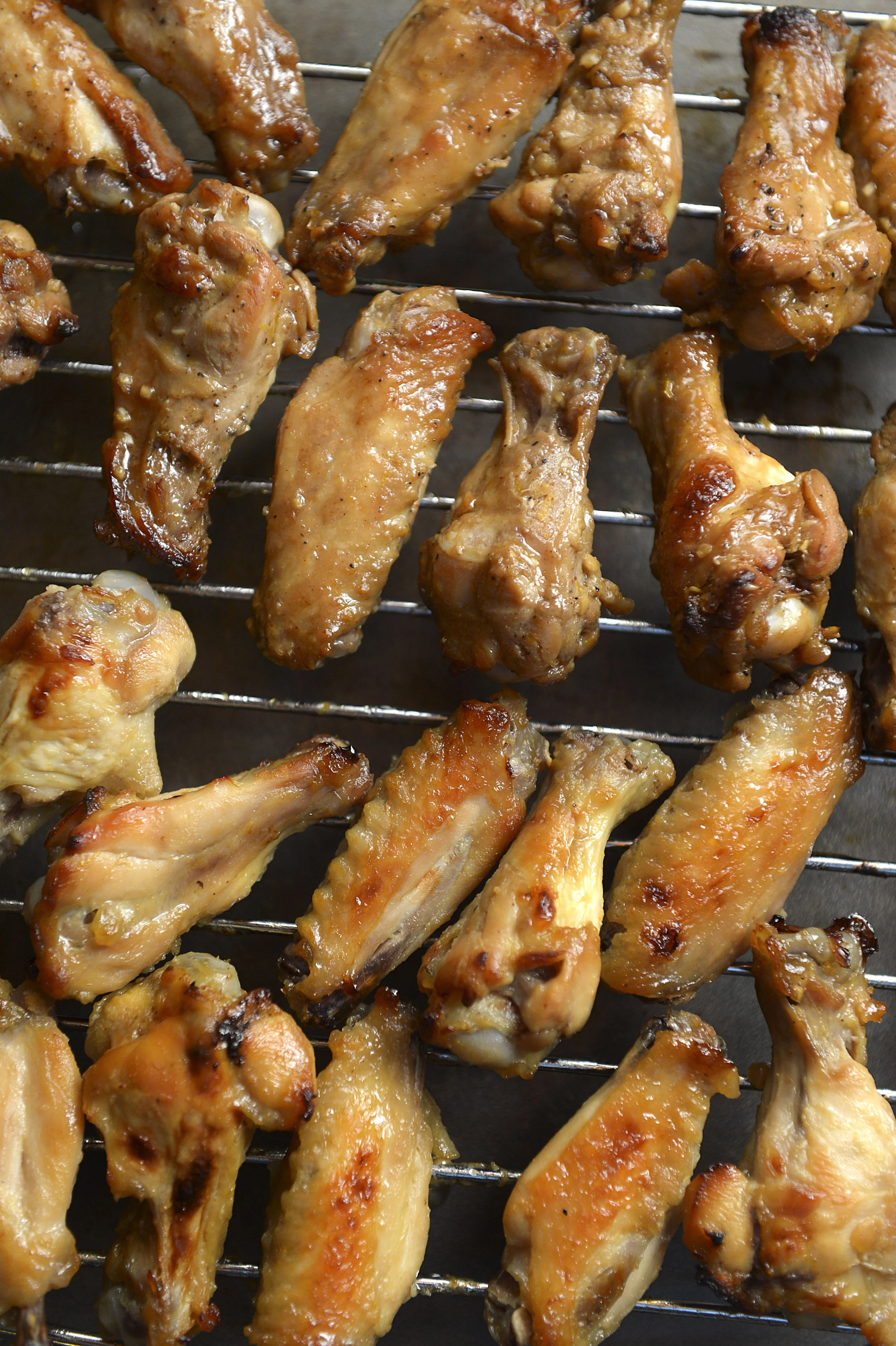 Grilled chicken wings on a metal rack