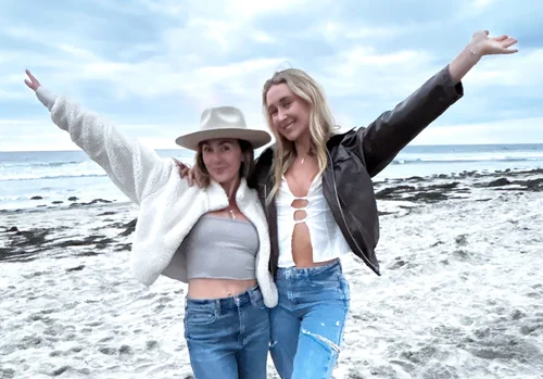Paige celebrating with a client at the beach