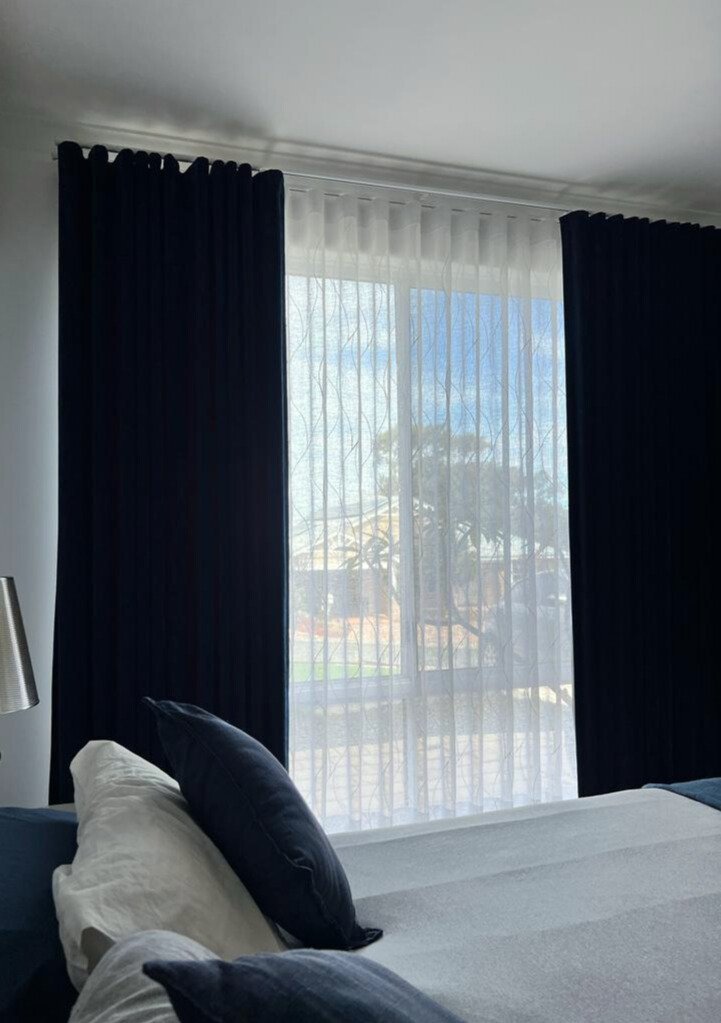 navy and gray bedroom with navy drapes