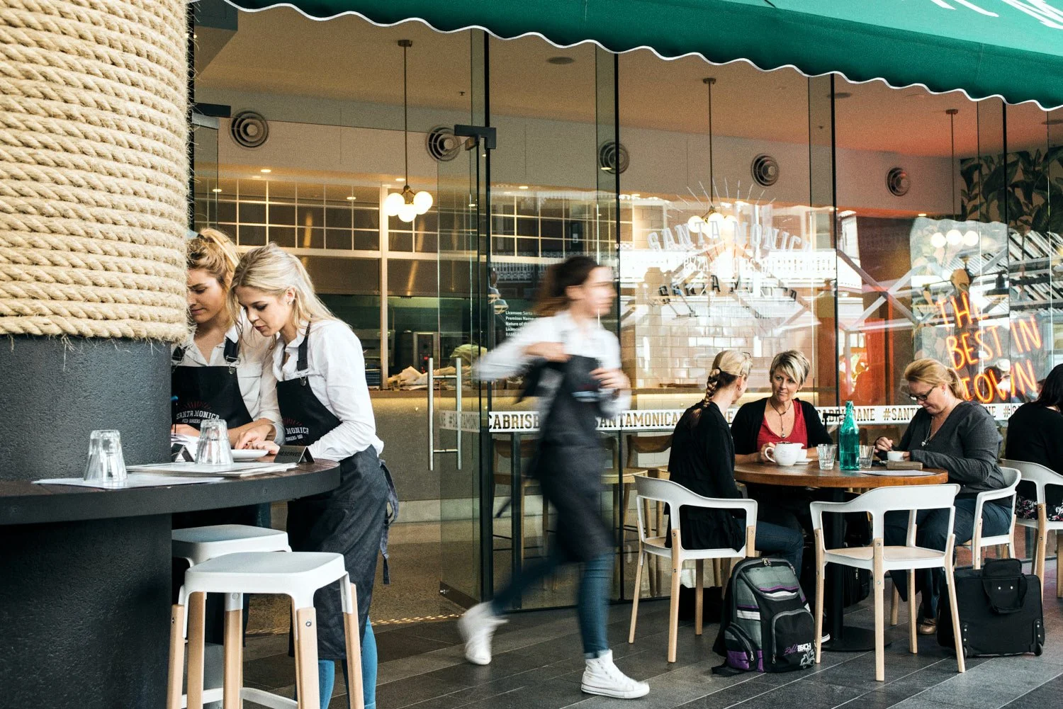 A commercial image of waitresses in a Brisbane restaurant taken by commercial photographer Tom MacDonald of Tom Mac photography.