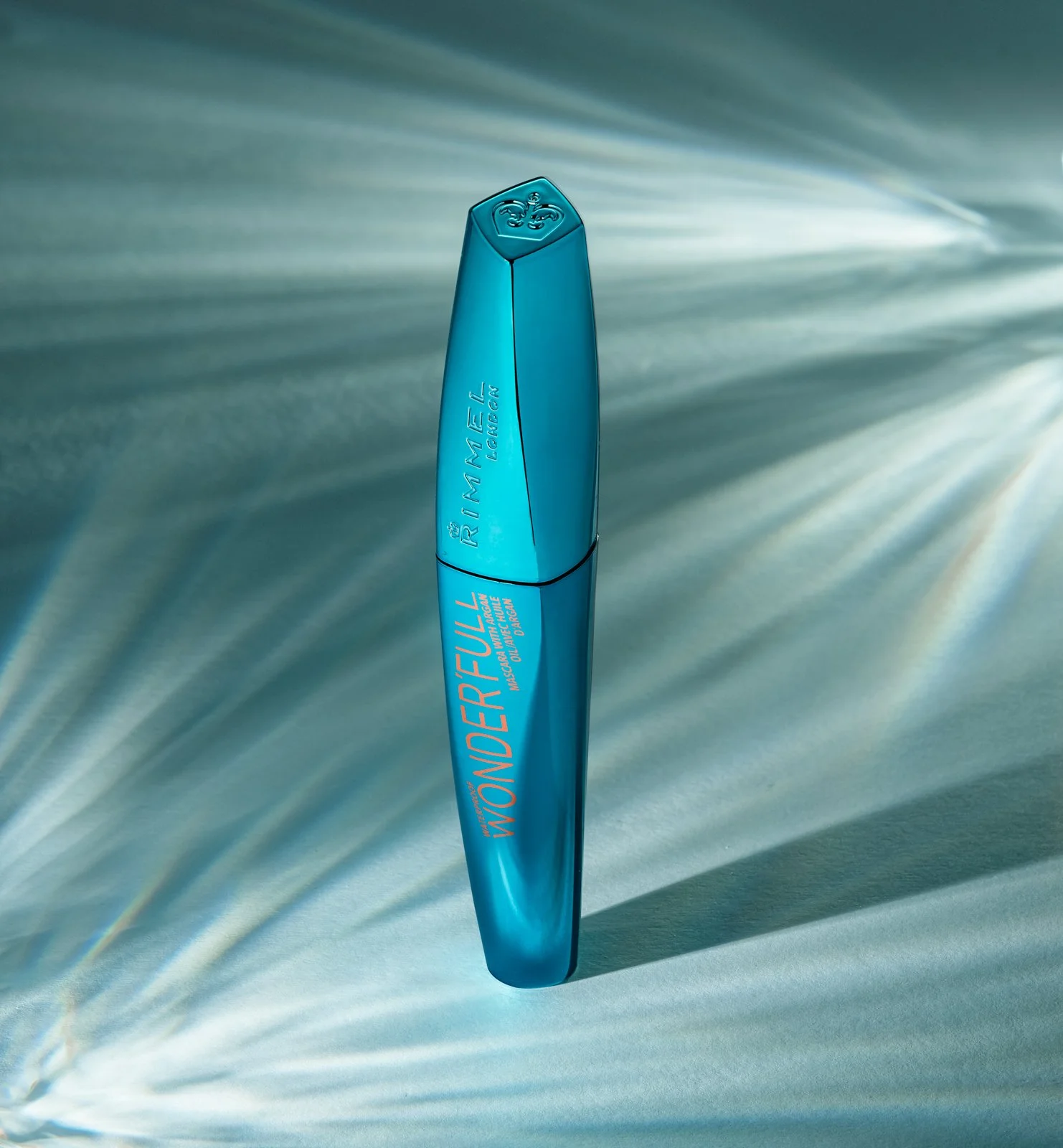 A creative image of blue cosmetics tube, on a light fracture background taken by Tom MacDonald, a commercial photographer in Brisbane.