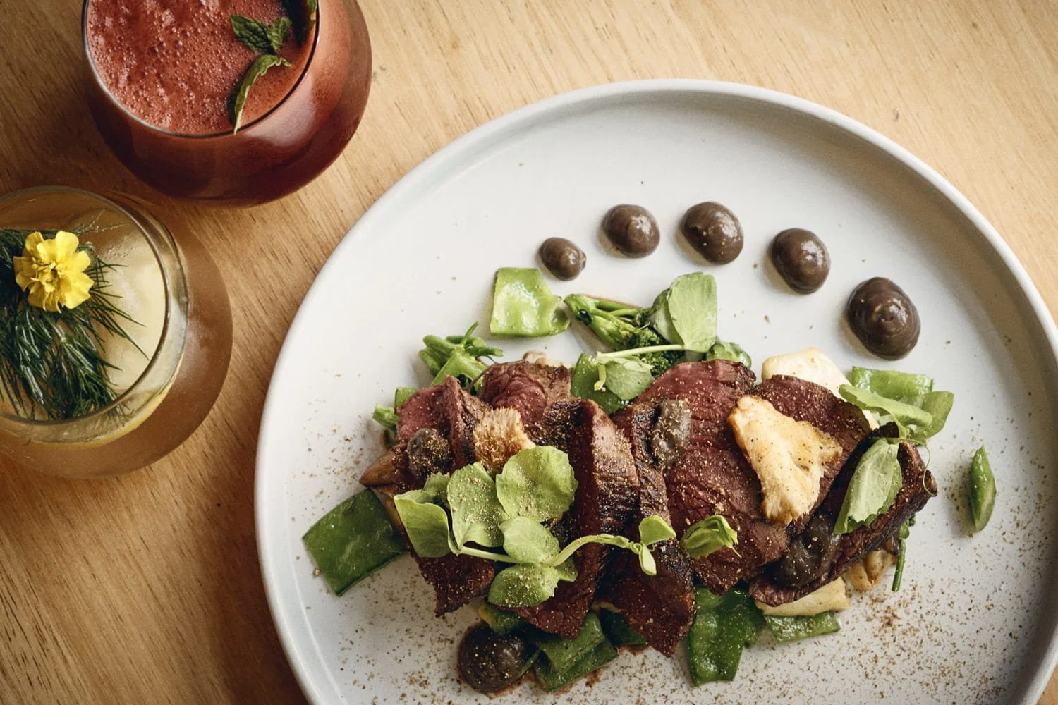 A commercial restaurant photograph of a plate of beef in a Brisbane business, taken by Commercial food photographer Tom MacDonald of Tom Mac photography.