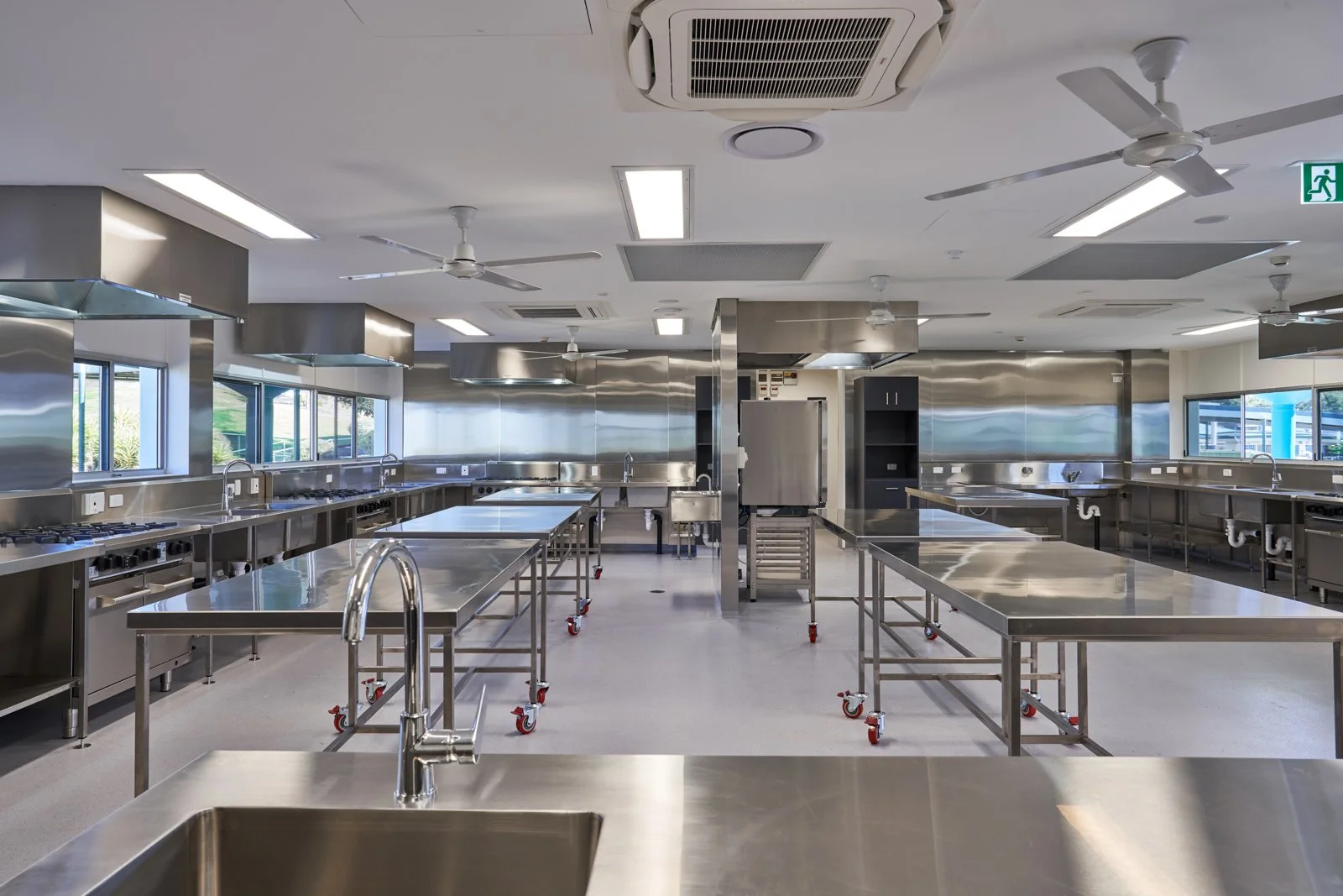A commercial image of empty commercial kitchen taken to show the quality of work by the design and building team. Taken By TomMac photography in Ipswich Queensland