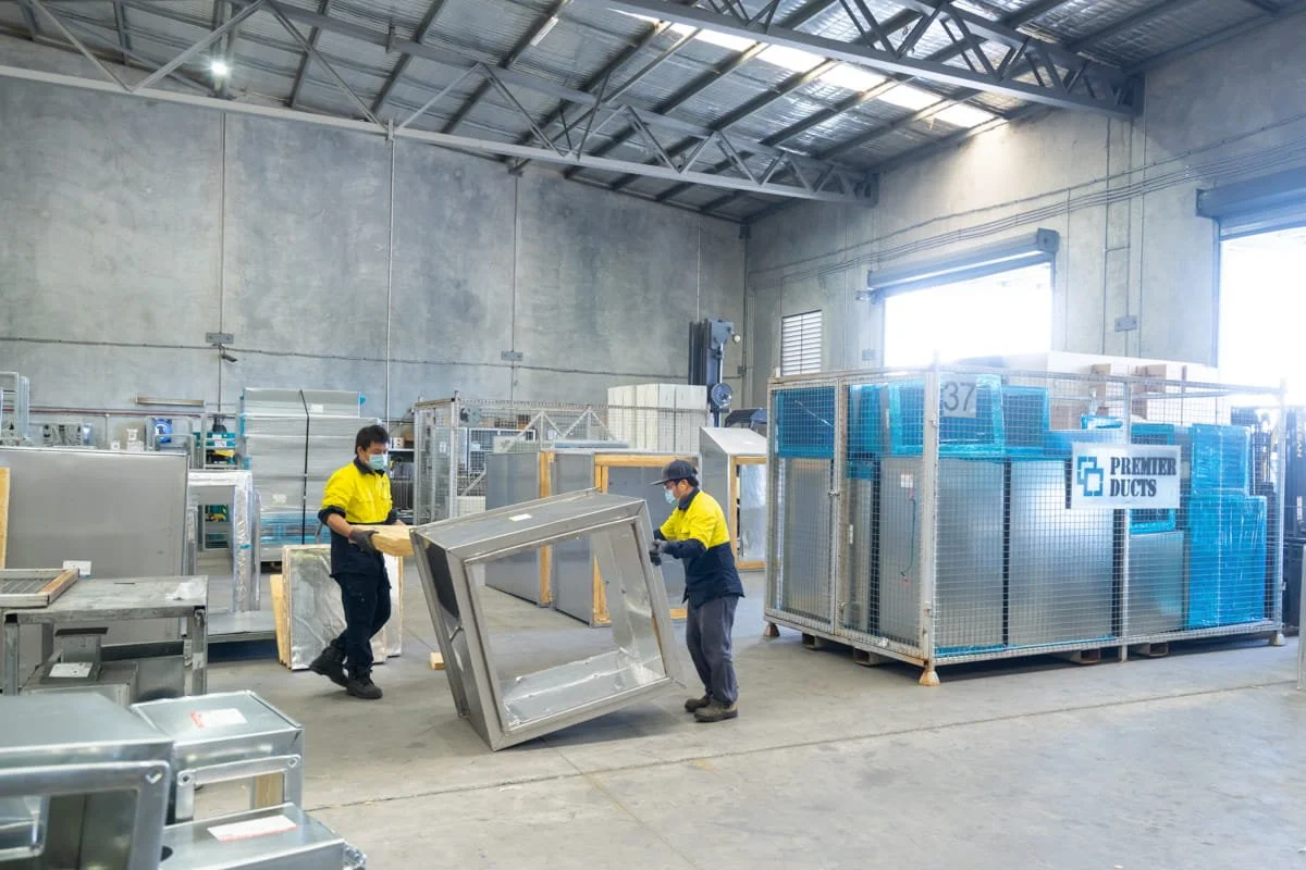 A commercial photograph of industrial workers in a Brisbane metal fabrication workshop, taken by commercial photographer Tom MacDonald of Tom Mac photography