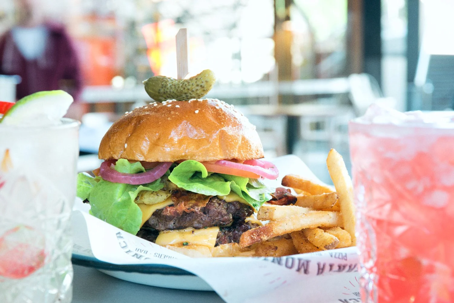 A commercial restaurant photograph of a cheeseburger in a Brisbane restaurant  taken by Commercial food photographer Tom MacDonald of Tom Mac photography.