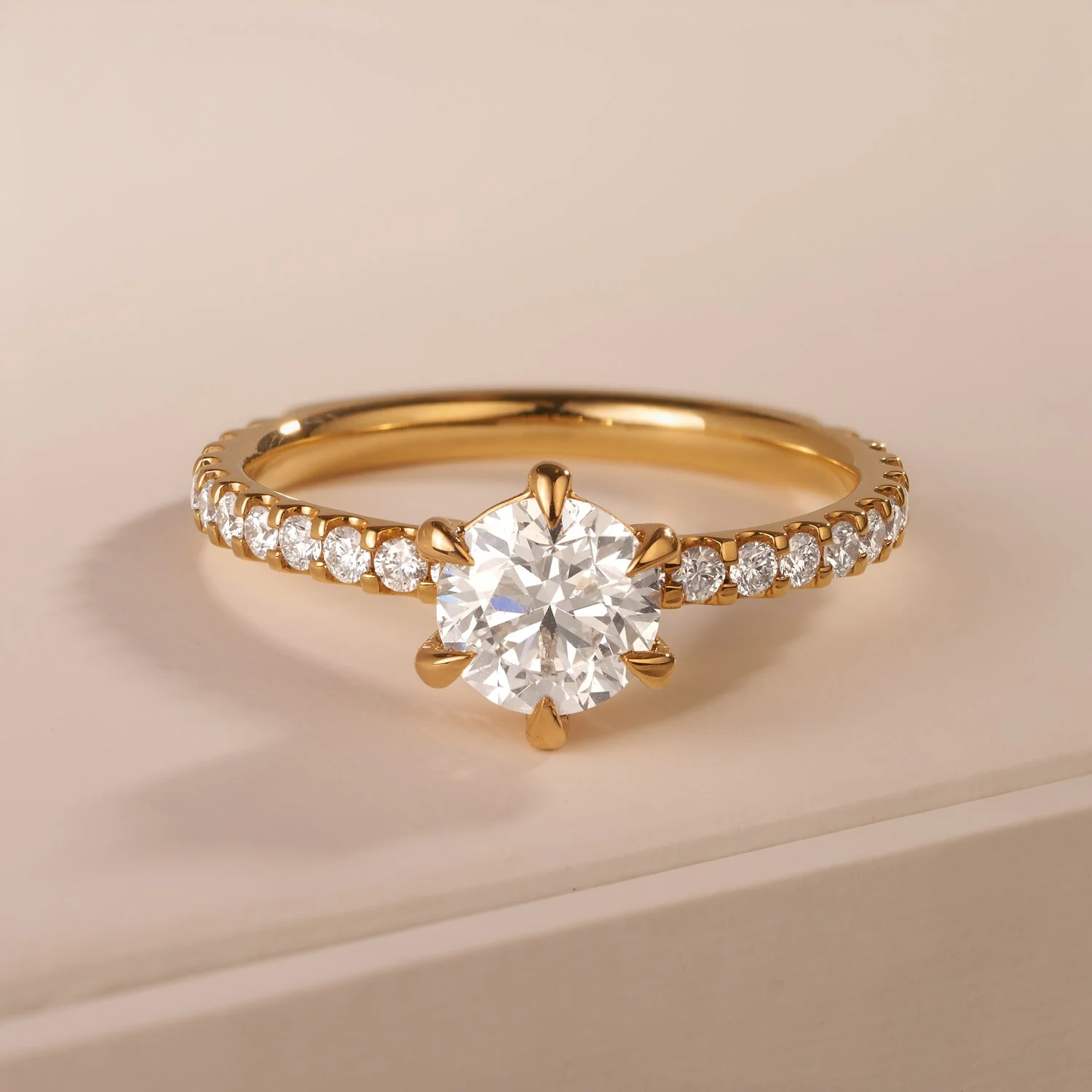 A  commercial jewellery image of a gold ring with a diamond solitaire and diamonds on the shoulders setting taken by Brisbane based commercial photographer Tom MacDonald for Hardy brothers jewellers.