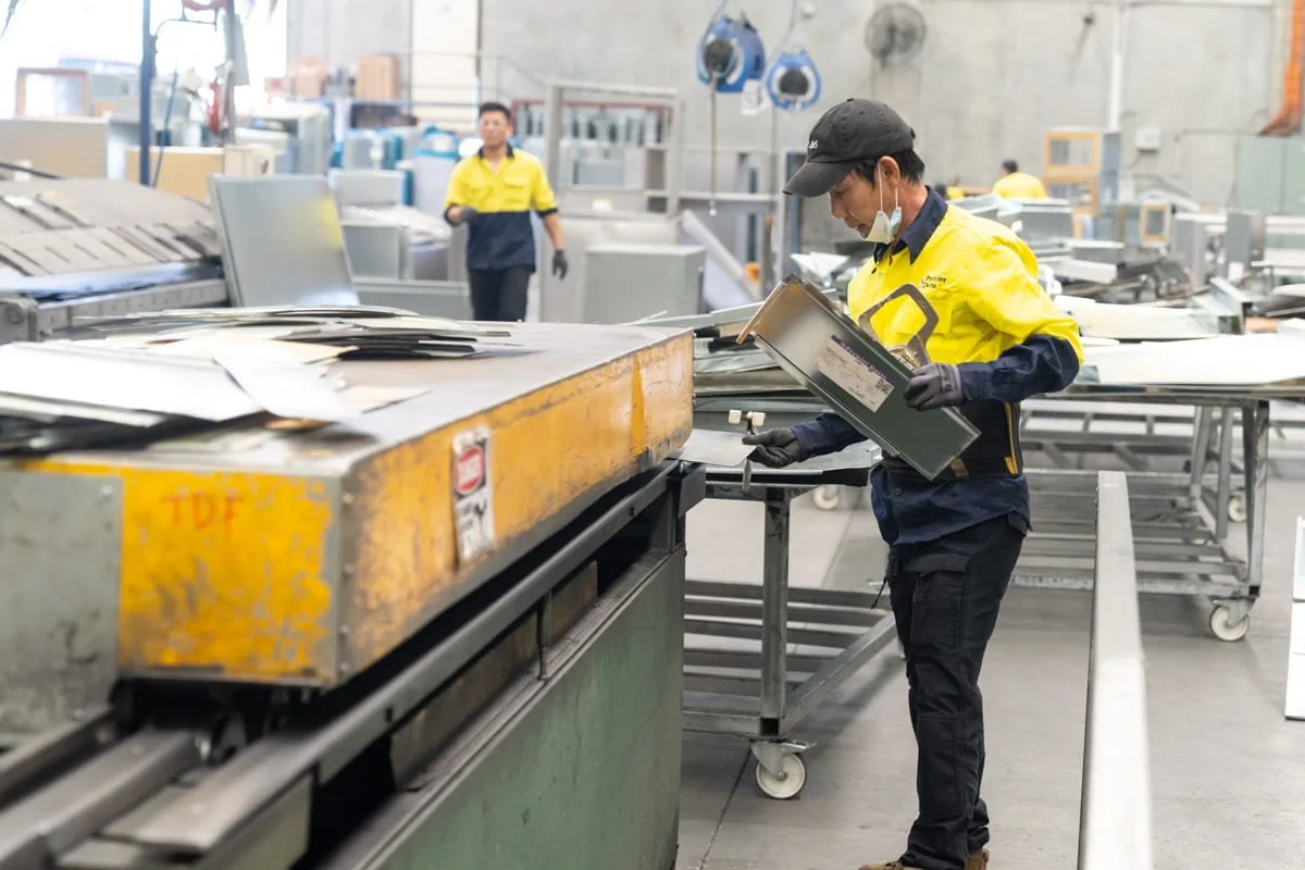 A commercial image of industrial workers in a Brisbane metal fabrication workshop, taken by commercial photographer Tom MacDonald of Tom Mac photography
