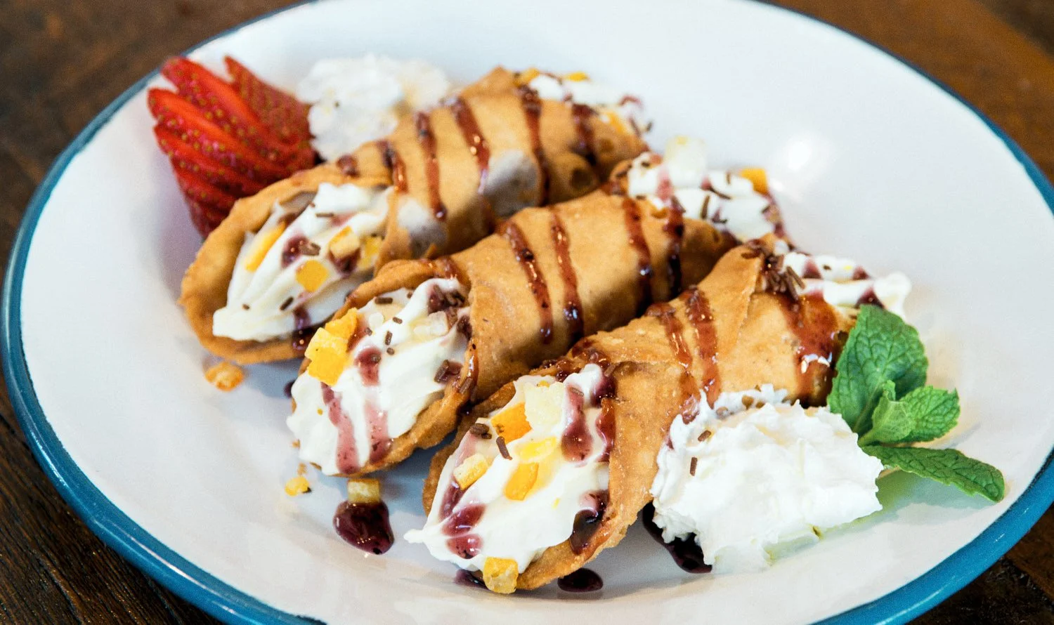 A commercial photograph of three fried ice cream sundaes wrapped in fried pastry shells, topped with whipped cream,  taken by Tom MacDonald of commercial photography company Tom Mac Photography.