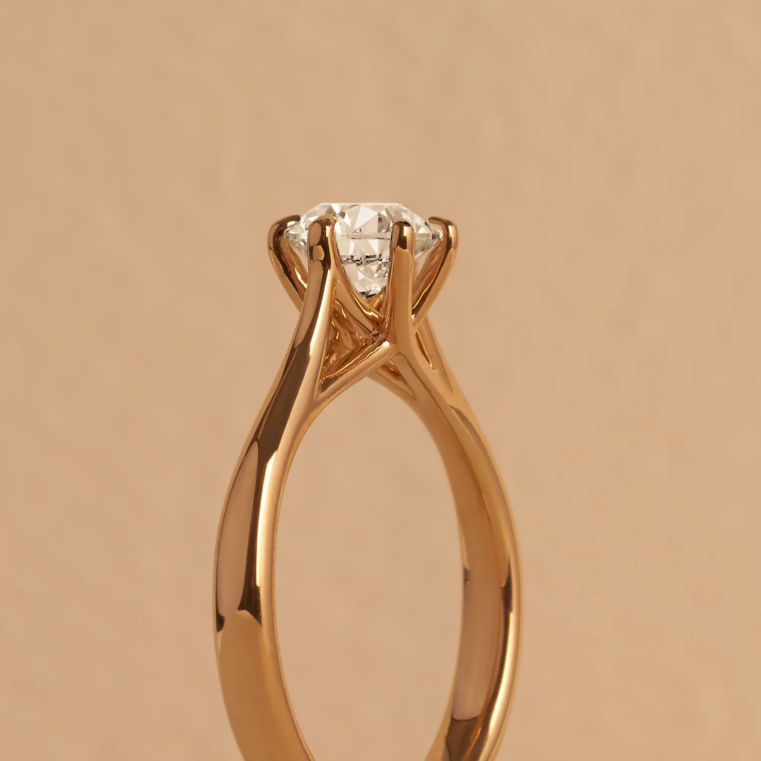 A  commercial jewellery photograph of a gold ring with a diamond solitaire setting taken by Brisbane based commercial photographer Tom MacDonald for Hardy brothers jewellers.
