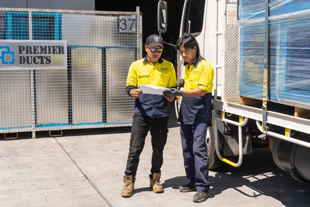 A commercial photograph of a delivery driver in a Brisbane metal fabrication factory, taken by commercial photographer Tom MacDonald of Tom Mac photography
