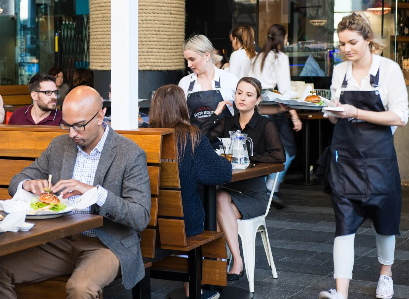 A commercial restuarant image of waitresses and customers taken in Brisbane by Tom Mac photography in Brisbane.