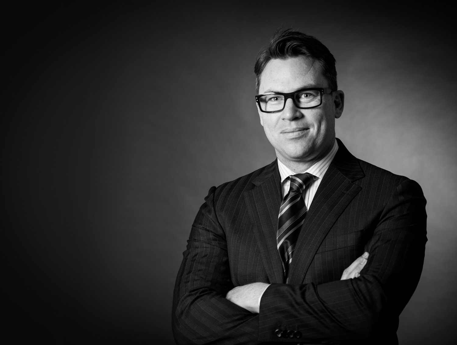 A commercial headshot of a lawyer with his arms crossed in Brisbane taken by TomMac Photography